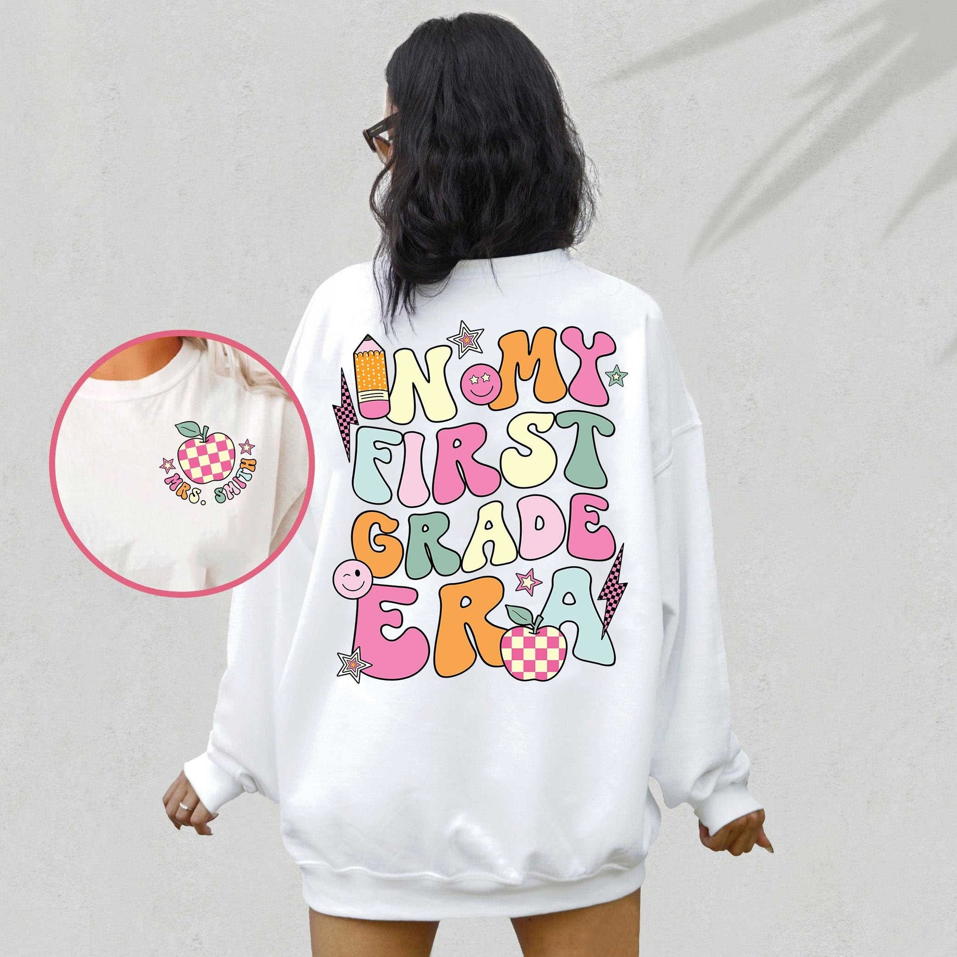 An energetic graphic with the phrase In my first grade era displayed in bold colorful letters The design includes playful symbols like a pencil apple stars and smiley faces adding a lively and positive touch