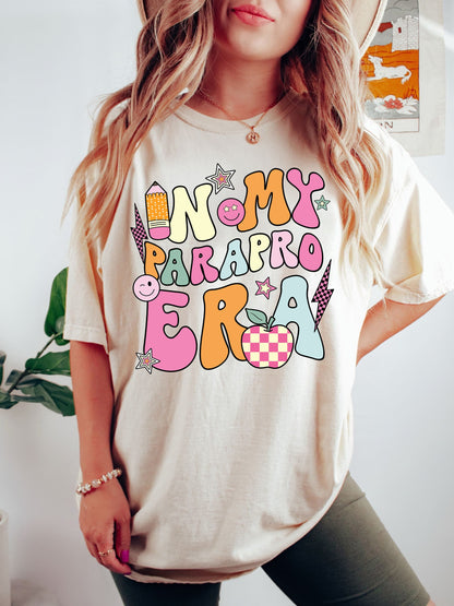 Paying homage to the paraprofessional experience, this design features IN MY PARA ERA written in an eclectic mix of vibrant colors and sizes, complemented by playful educational motifs including a cheerful paintbrush