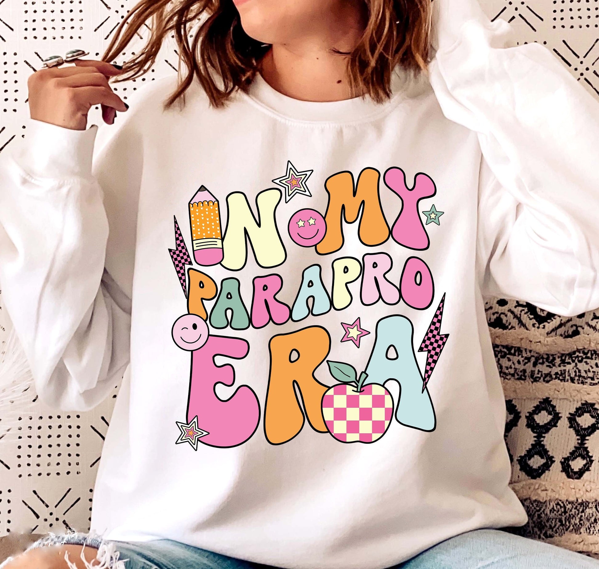 The illustration proudly proclaims IN MY PARA ERA in an array of dynamic, colorful lettering, dotted with whimsical education-related images like a grinning paintbrush and palette, alongside a checkered apple