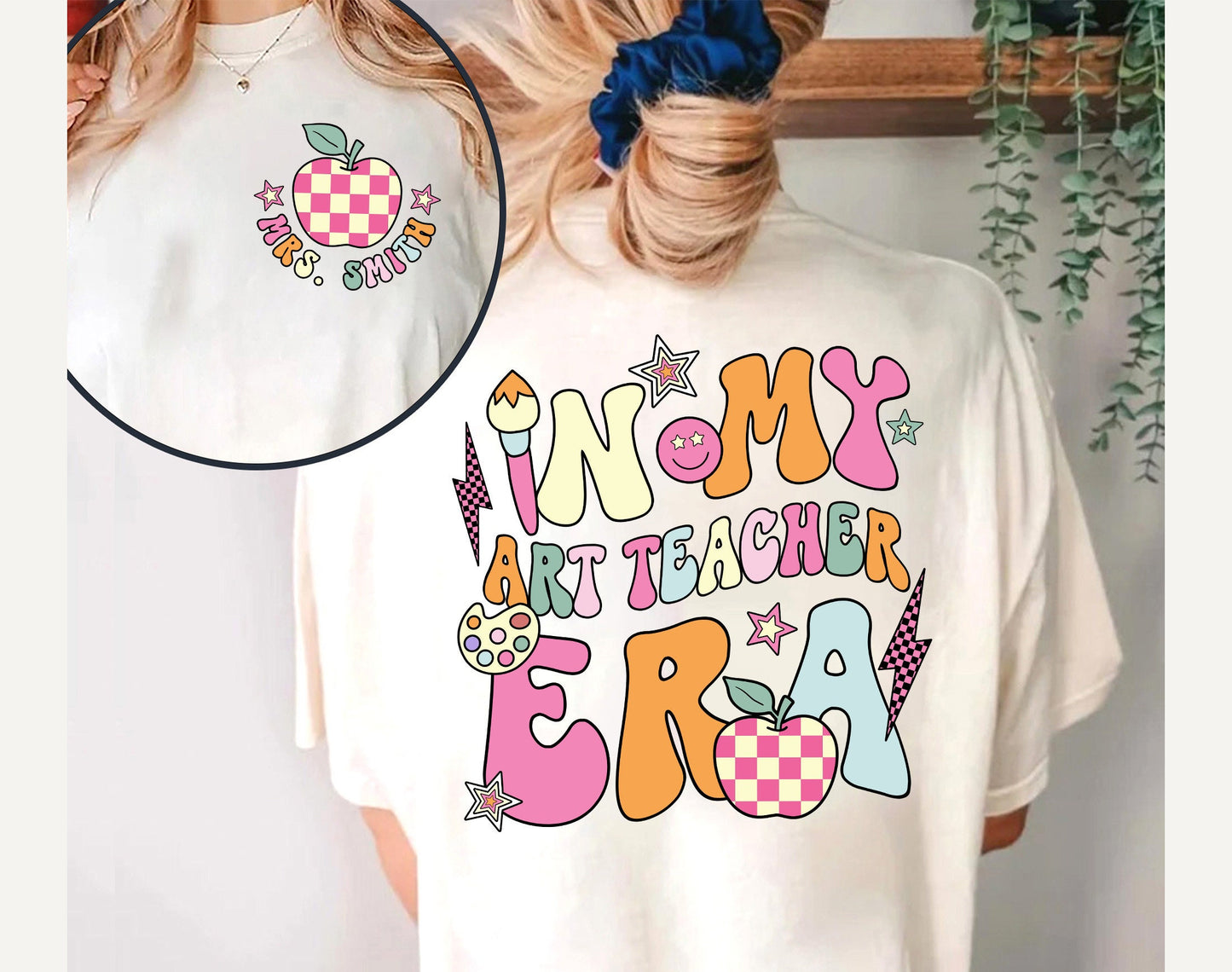 A bright and cheerful acknowledgment of the role of art in education, the design spells out IN MY ART TEACHER ERA in playful lettering, complemented with symbols of creativity and learning like a paintbrush, a smiling palette