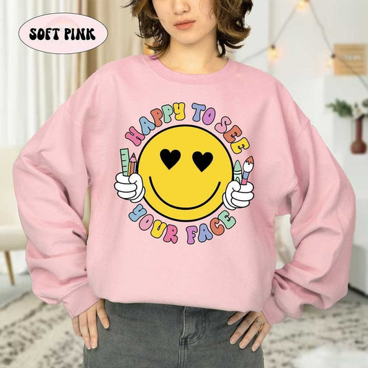 A radiant yellow smiley face holds school supplies, framed by the colorful message HAPPY TO SEE YOUR FACE in a friendly and welcoming design.