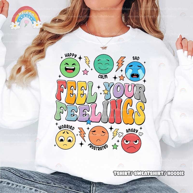 A lively and supportive design that depicts the phrase FEEL YOUR FEELINGS, illustrated in soft pastel hues, encircled by a variety of emoticons displaying different feelings, highlighted with whimsical star and lightning bolt shapes.
