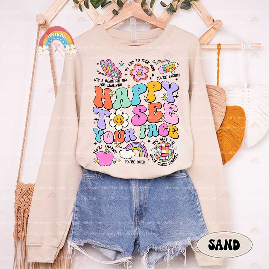 A cheerful message, HAPPY TO SEE YOUR FACE, is presented in a spectrum of bold and pastel hues, interspersed with charming icons like a smiling daisy, a pastel butterfly, and a stylized rainbow, all set against a dark backdrop.