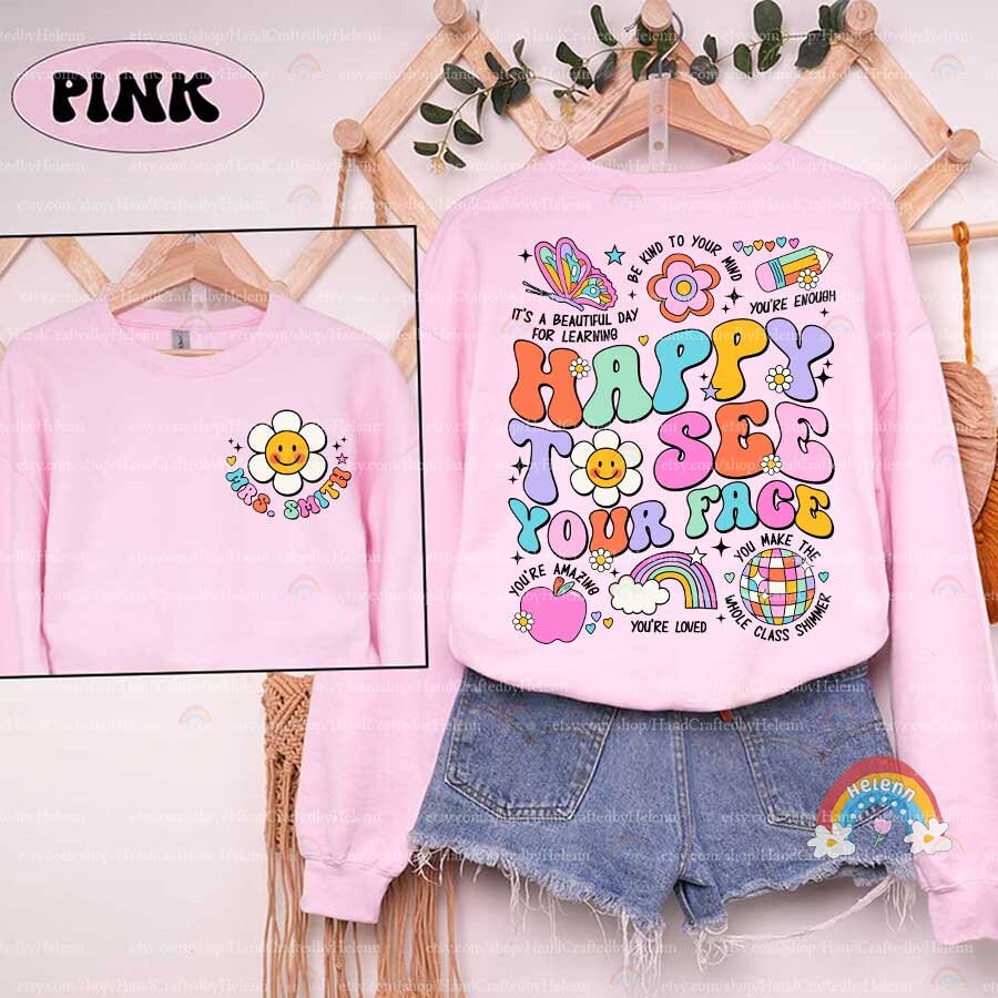 The phrase HAPPY TO SEE YOUR FACE is crafted in a kaleidoscope of playful colors and surrounded by a collection of joyous images such as a pencil, an apple, and a disco ball, creating a festive and friendly vibe.