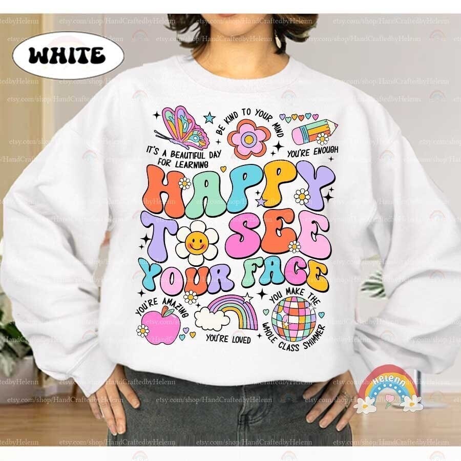 A warm and colorful greeting stands out with the message HAPPY TO SEE YOUR FACE, playfully illustrated with a patchwork of bright colors, friendly flowers, and whimsical drawings including a butterfly and a rainbow.