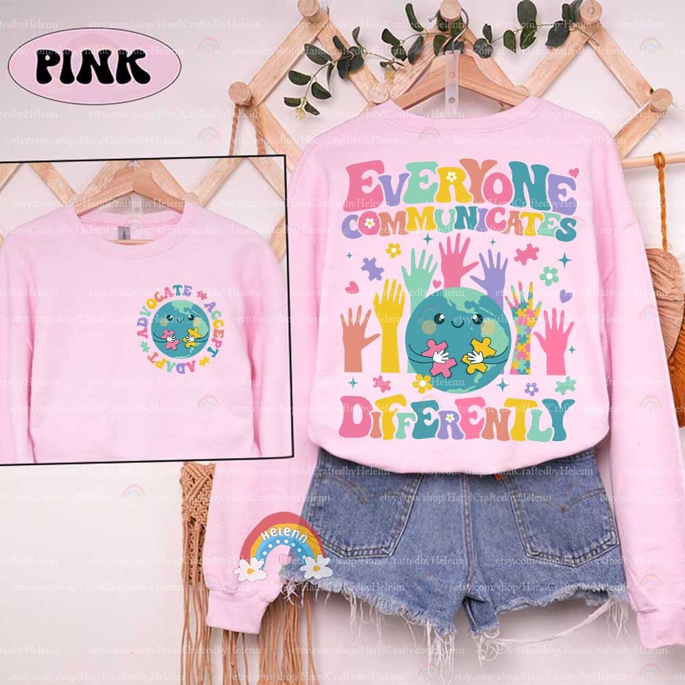 The illustration encapsulates the beauty of diverse interactions with a central globe character piecing together puzzles, encircled by a variety of vibrant hands reaching in, all beneath the guiding words EVERYONE COMMUNICATES DIFFERENTLY