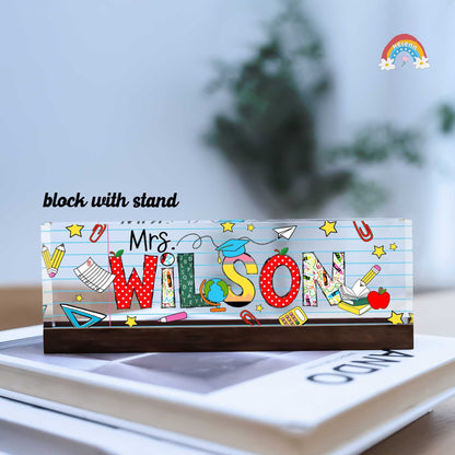 Decorated with education-themed illustrations like a globe, apple, pencil, and notebook, this block creatively integrates tools associated with learning and teaching.
