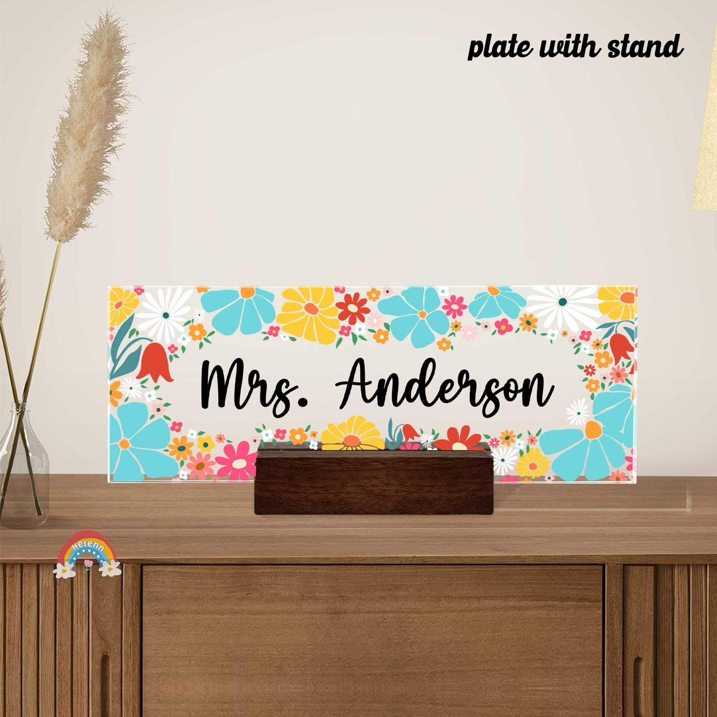 The design combines various flowers in shades of orange, blue, and pink, interspersed with green leaves, creating a vibrant backdrop