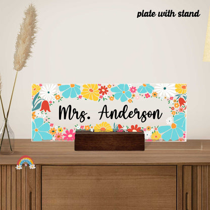 The design combines various flowers in shades of orange, blue, and pink, interspersed with green leaves, creating a vibrant backdrop