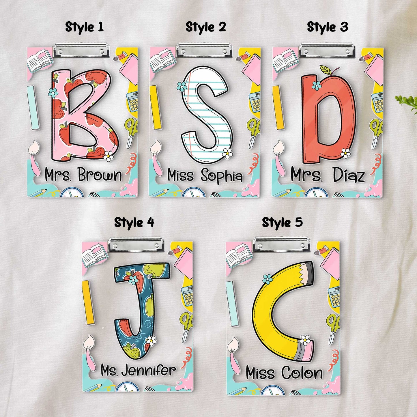 A playful and educational design featuring the letters S and B on decorated clipboards Each letter has a unique pattern and the clipboards are enhanced with items like books and pencils along with the teacher&#39;s name at the bottom