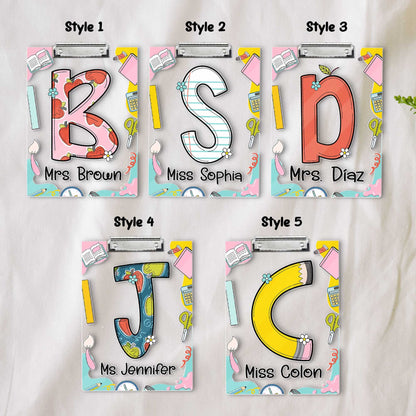 A playful and educational design featuring the letters S and B on decorated clipboards Each letter has a unique pattern and the clipboards are enhanced with items like books and pencils along with the teacher&#39;s name at the bottom