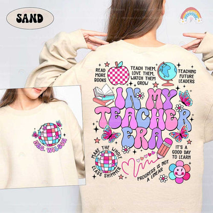 A creative tribute to teaching, showcasing blue and pink letters, surrounded by symbols of learning such as a smiling flower and a disco ball globe.