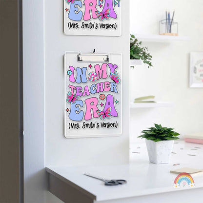 This eye-catching clipboard features the phrase In My Teacher Era in large, pastel letters, adorned with butterflies and geometric patterns, tailored specifically for Mrs. Smith.