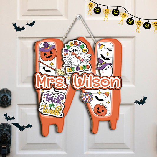Celebrate the Halloween season with Mrs. Wilson&#39;s playful door decoration, showcasing adorable ghost and pumpkin illustrations with a vibrant orange and white color scheme.