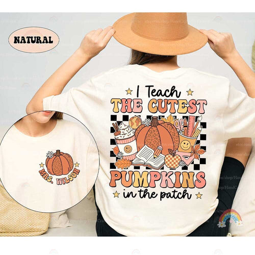This charming design features a leopard-print pumpkin surrounded by school supplies, fall leaves, and a cozy cup of cocoa, all set against a black background with bold, colorful text.