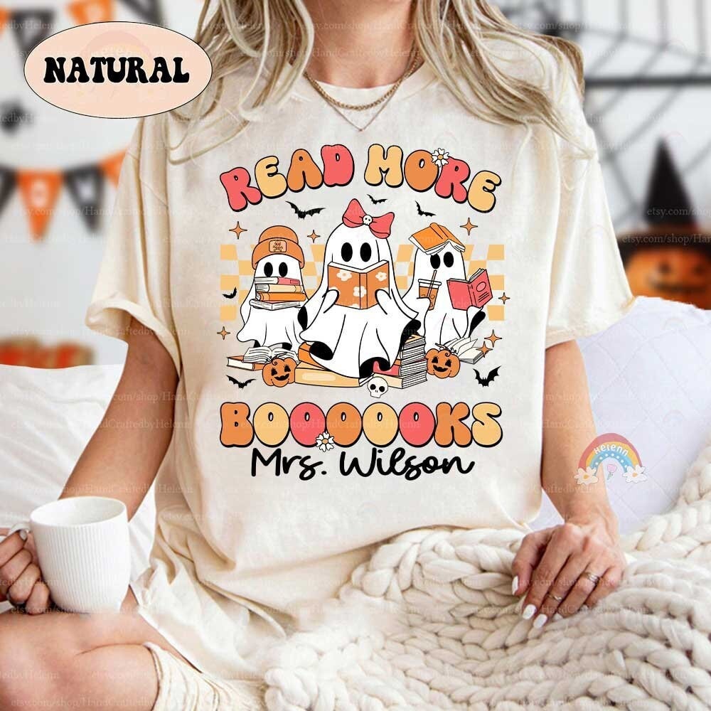 Festive image with three whimsical ghosts reading, surrounded by autumnal elements on a black background with a playful phrase.