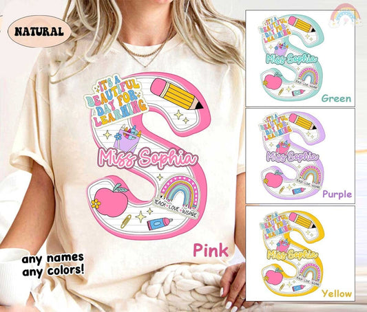 An attractive layout with the name set against a backdrop of school-themed illustrations including a rainbow and stars, perfect for a teacher with a lively personality.