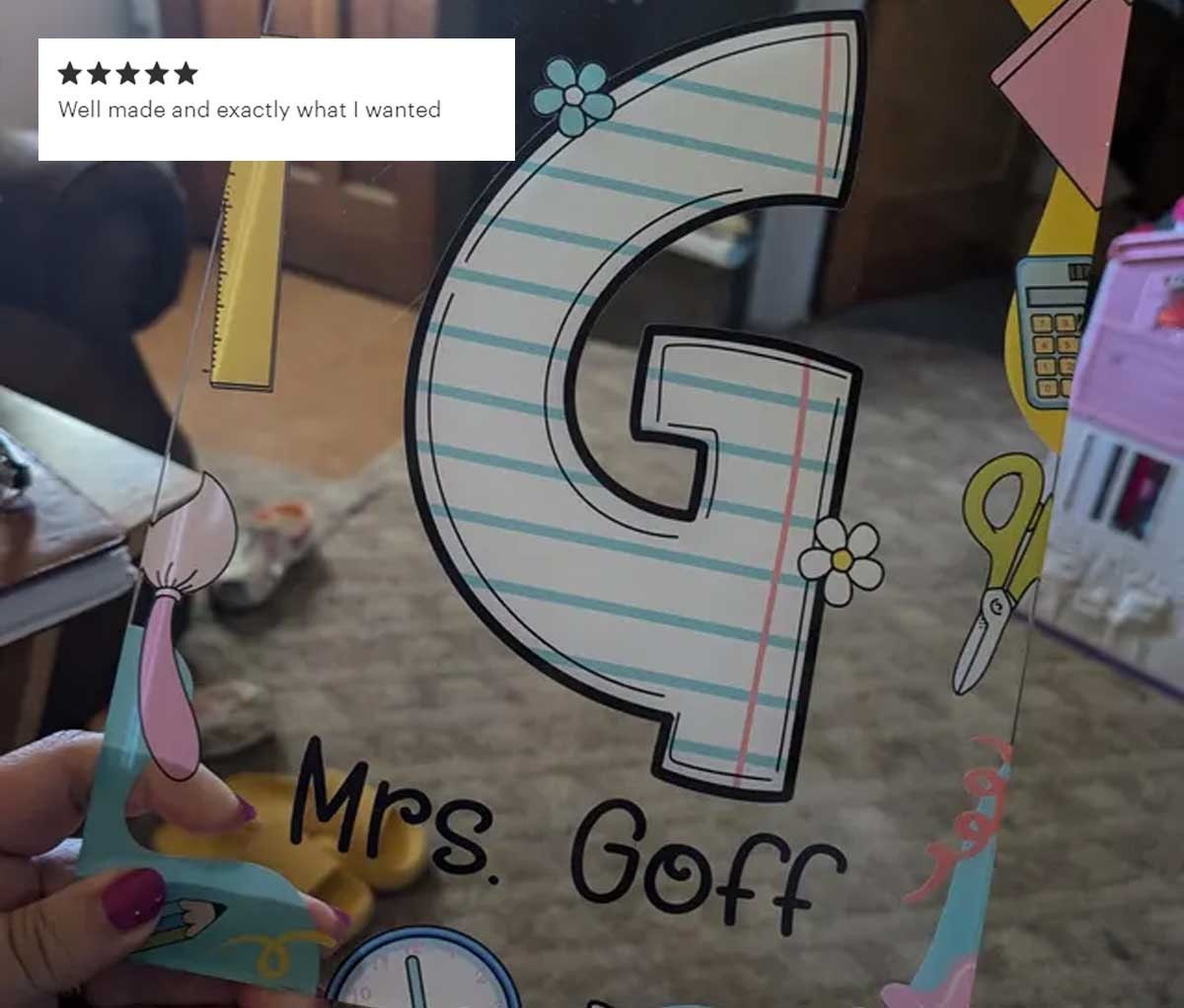 A lively teacher design with large letters S and B on clipboards decorated with patterns such as flowers and lined paper The clipboards are filled with educational icons and include the teacher&#39;s name for a personalized touch