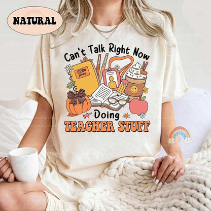 The Teacher Stuff design features an assortment of classroom essentials, including lesson plans, pens, and books, surrounded by autumn-themed decorations.