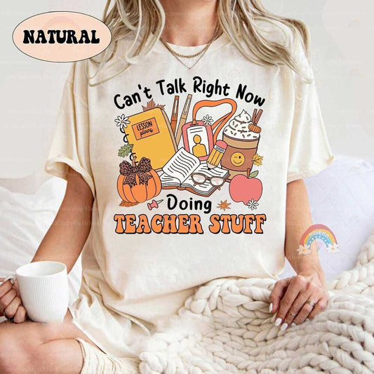 The Teacher Stuff design features an assortment of classroom essentials, including lesson plans, pens, and books, surrounded by autumn-themed decorations.