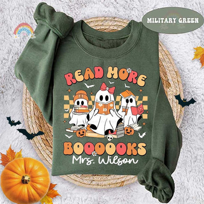 Colorful illustration shows three friendly ghosts with Halloween-themed decorations promoting reading.