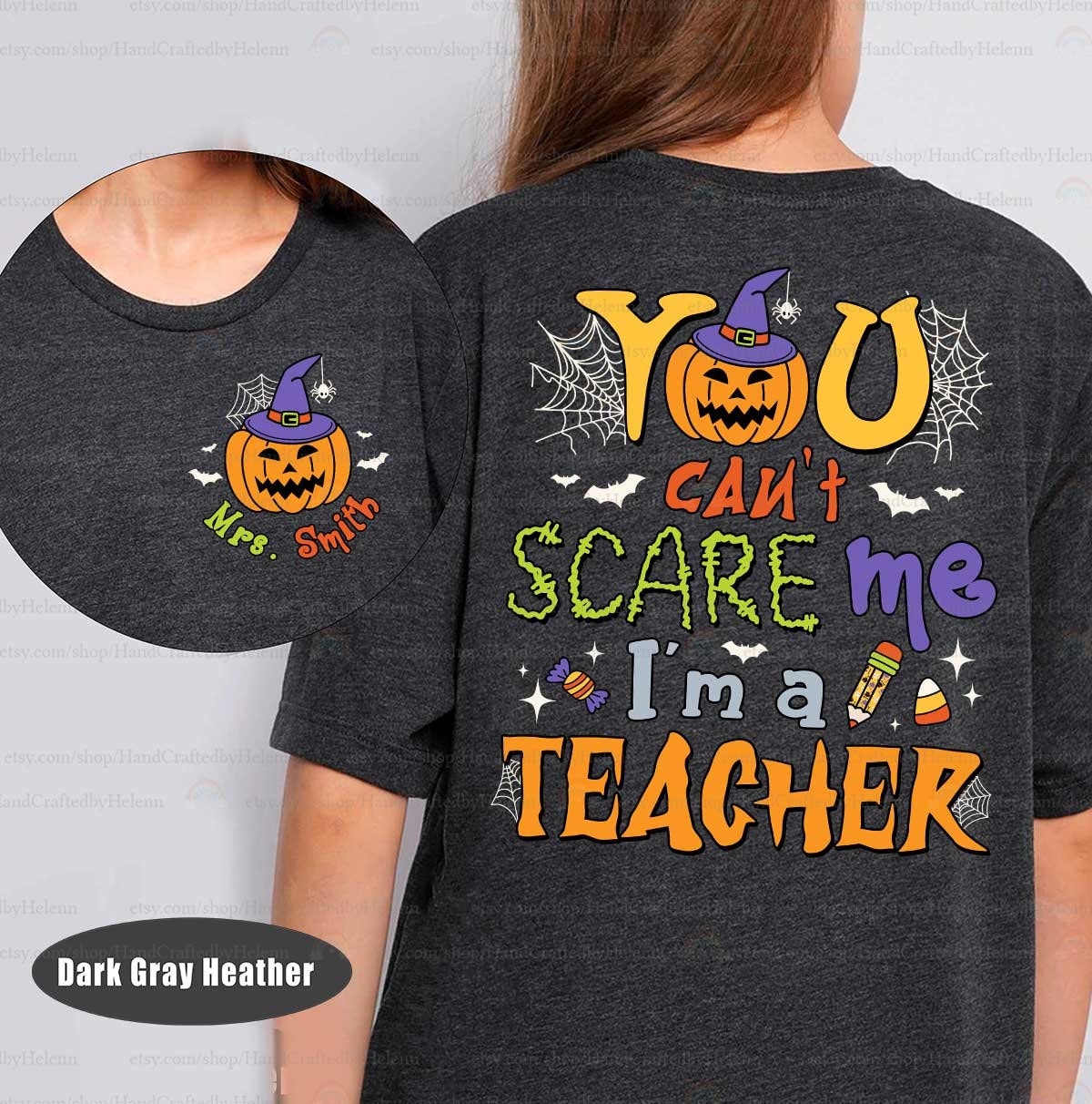 A lively Halloween-themed graphic featuring You can&#39;t scare me I&#39;m a teacher in bold fonts surrounded by festive icons like a jack-o&#39;-lantern with a witch hat spider webs bats and candy making it perfect for the season