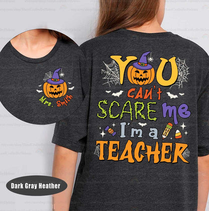 A lively Halloween-themed graphic featuring You can&#39;t scare me I&#39;m a teacher in bold fonts surrounded by festive icons like a jack-o&#39;-lantern with a witch hat spider webs bats and candy making it perfect for the season