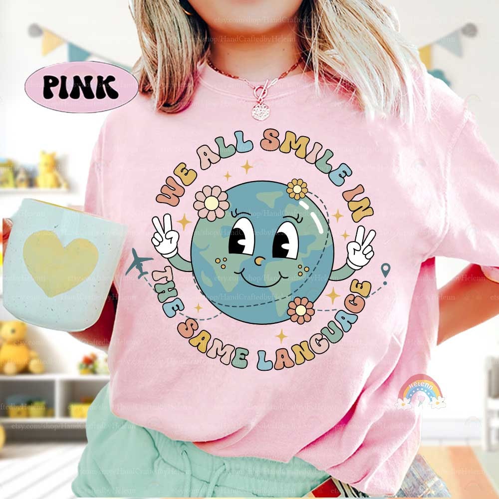 A joyful design featuring a happy globe with peace signs and the words We all smile in the same language The design is accented with flowers and an airplane creating a theme of worldwide friendship and unity