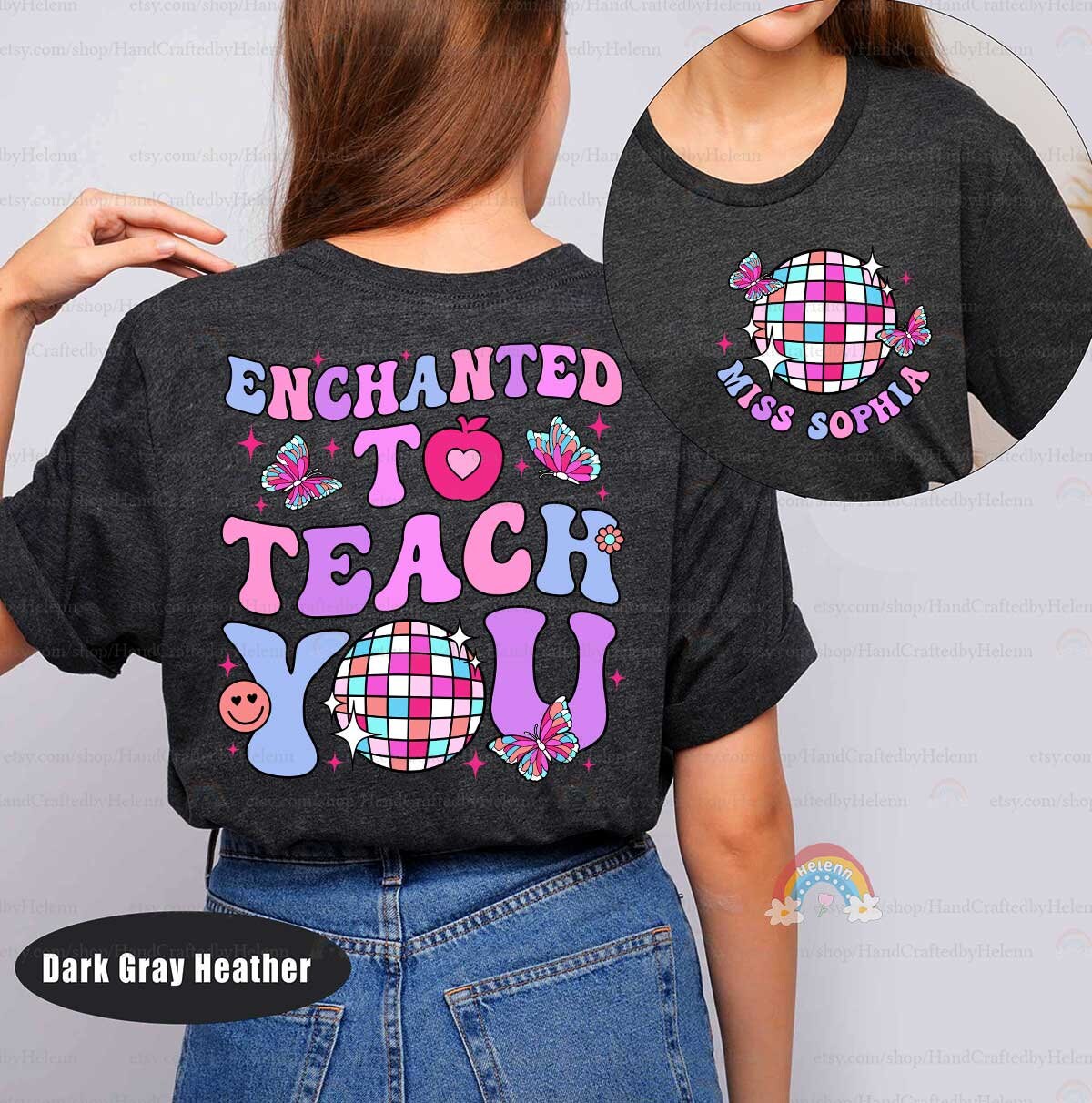 A vibrant and fun graphic with Enchanted to Teach You displayed in large, colorful fonts, decorated with butterflies, a heart apple, and a disco ball, perfect for a magical teaching vibe.