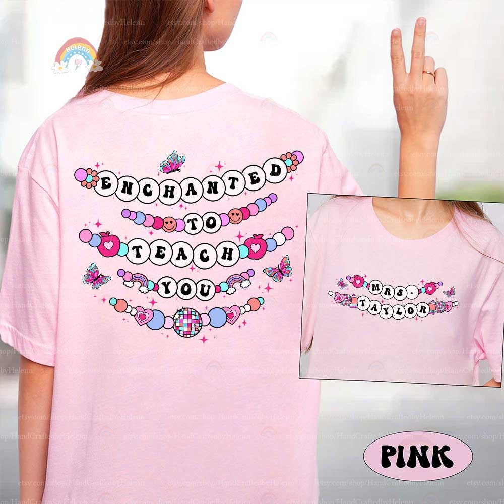 Whimsical and enchanting T-shirt design featuring beaded-style text that says Enchanted to Teach You, accented by butterflies, hearts, and playful details. The personalized name on the front makes it extra special for any teacher.