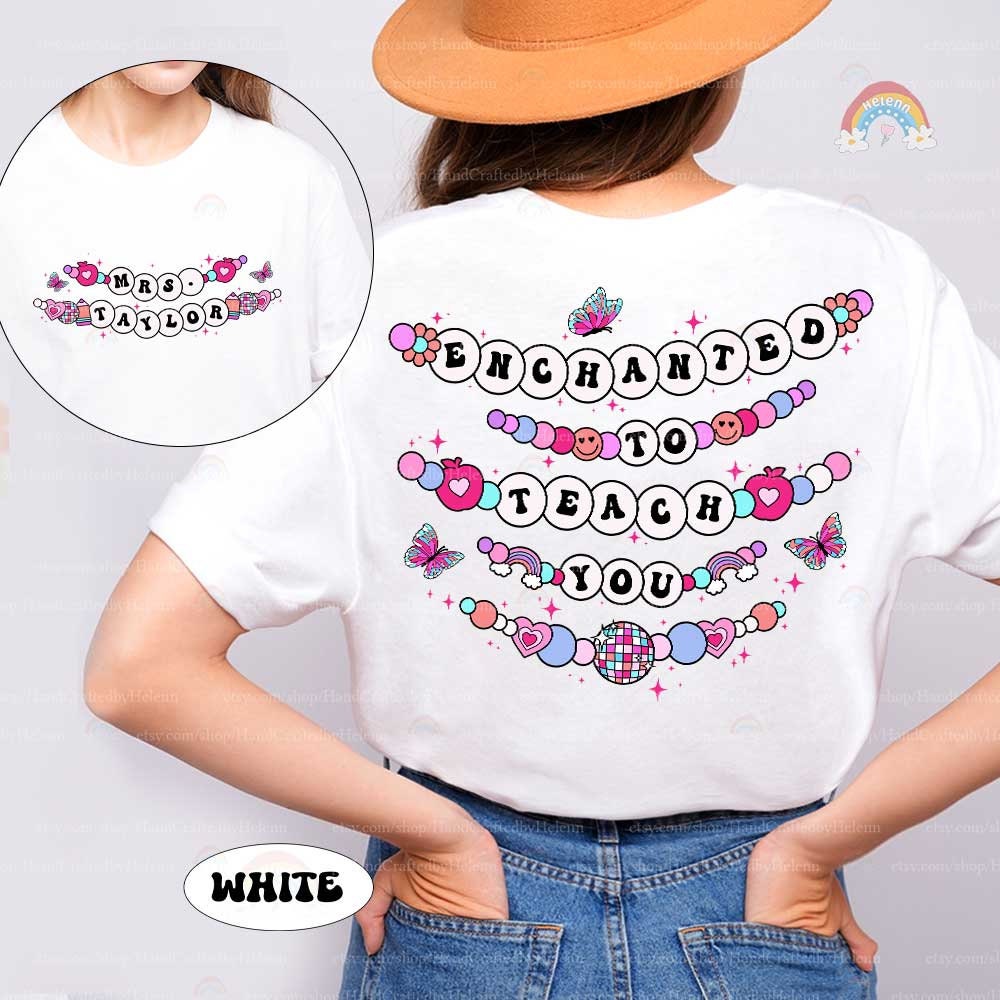 This T-shirt showcases a magical theme with the phrase Enchanted to Teach You, creatively arranged with beaded letters, butterflies, and hearts. The custom name on the front adds a unique, personal element to this enchanting design.