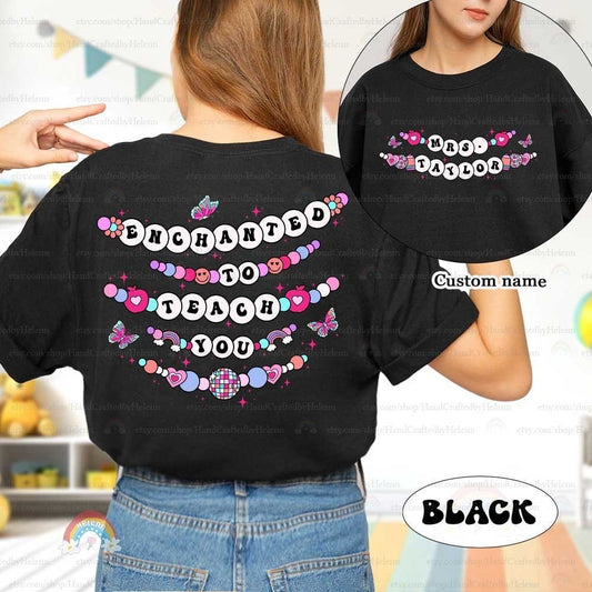 Charming and whimsical T-shirt design with the phrase Enchanted to Teach You, surrounded by colorful beaded elements, butterflies, and hearts. The custom name on the front adds a personalized touch to this delightful and playful theme.