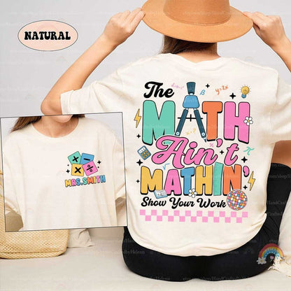 A playful design featuring the phrase The math ain&#39;t mathin&#39; with colorful letters and math-themed icons like a compass and calculator plus Show your work below.