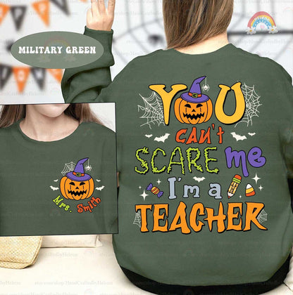 A lively Halloween-themed graphic featuring You can&#39;t scare me I&#39;m a teacher in bold fonts surrounded by festive icons like a jack-o&#39;-lantern with a witch hat spider webs bats and candy making it perfect for the season