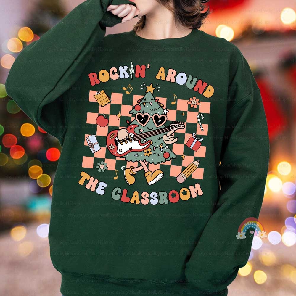 This holiday-themed T-shirt combines a rocking Christmas tree playing guitar with cheerful classroom elements like apples, books, and presents. The vibrant colors and fun details make it perfect for spreading holiday joy in the classroom.