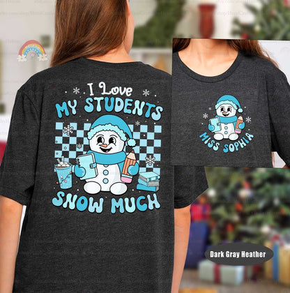 Cheerful and cozy T-shirt featuring a happy snowman holding school supplies, with the phrase I Love My Students Snow Much, perfect for bringing some winter fun to the classroom.