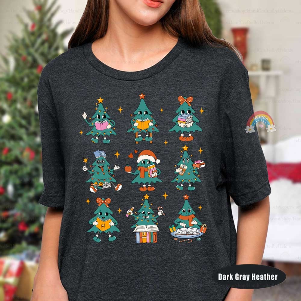 This vibrant holiday T-shirt shows a series of Christmas tree characters with books, pencils, and holiday accents, adding a fun and educational twist to seasonal celebrations.