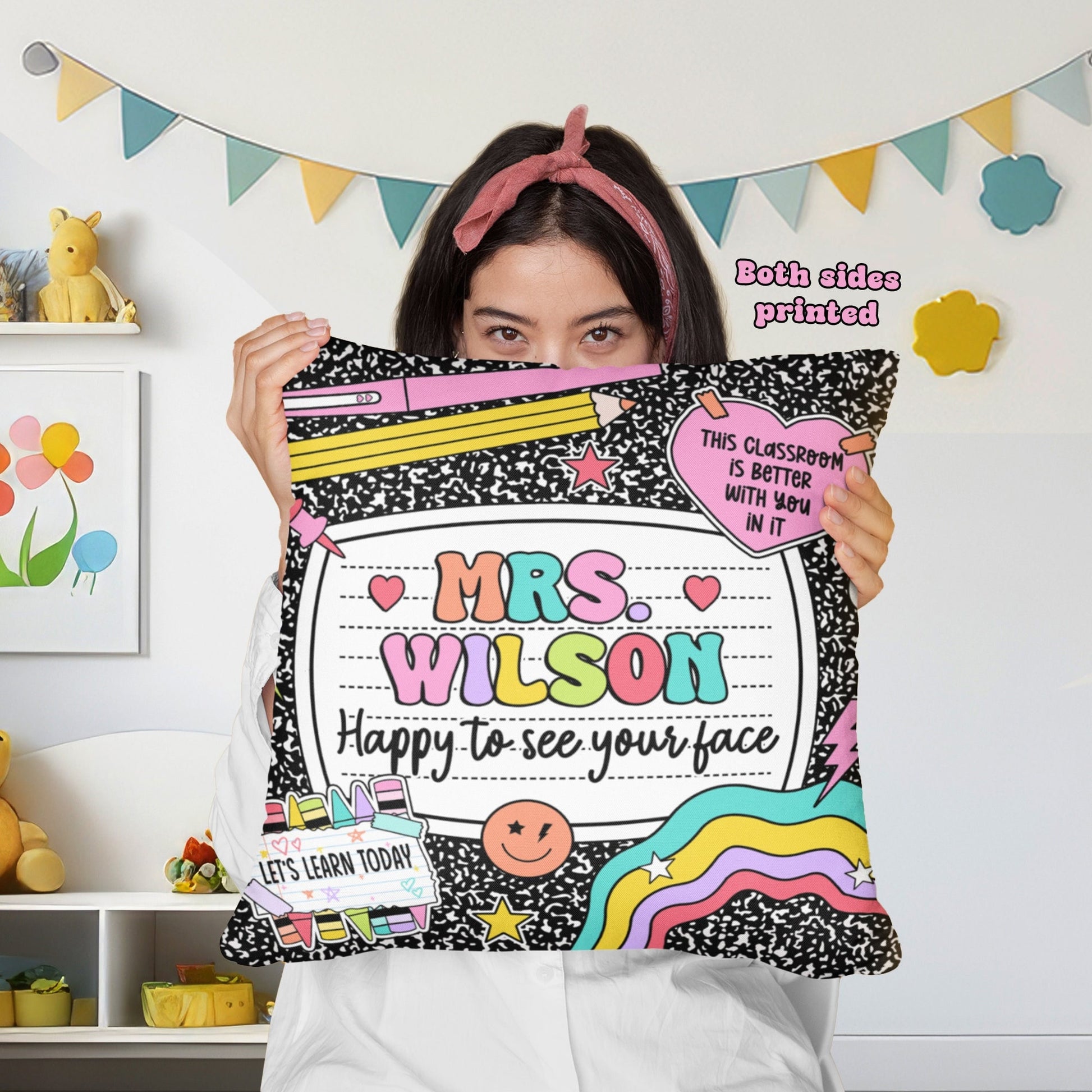 Fun and colorful personalized pillow featuring Mrs. Wilson’s name with the phrase Happy to see your face. The design is decorated with pencils, rainbows, and playful classroom-themed elements, making it a perfect addition to any teacher’s space.