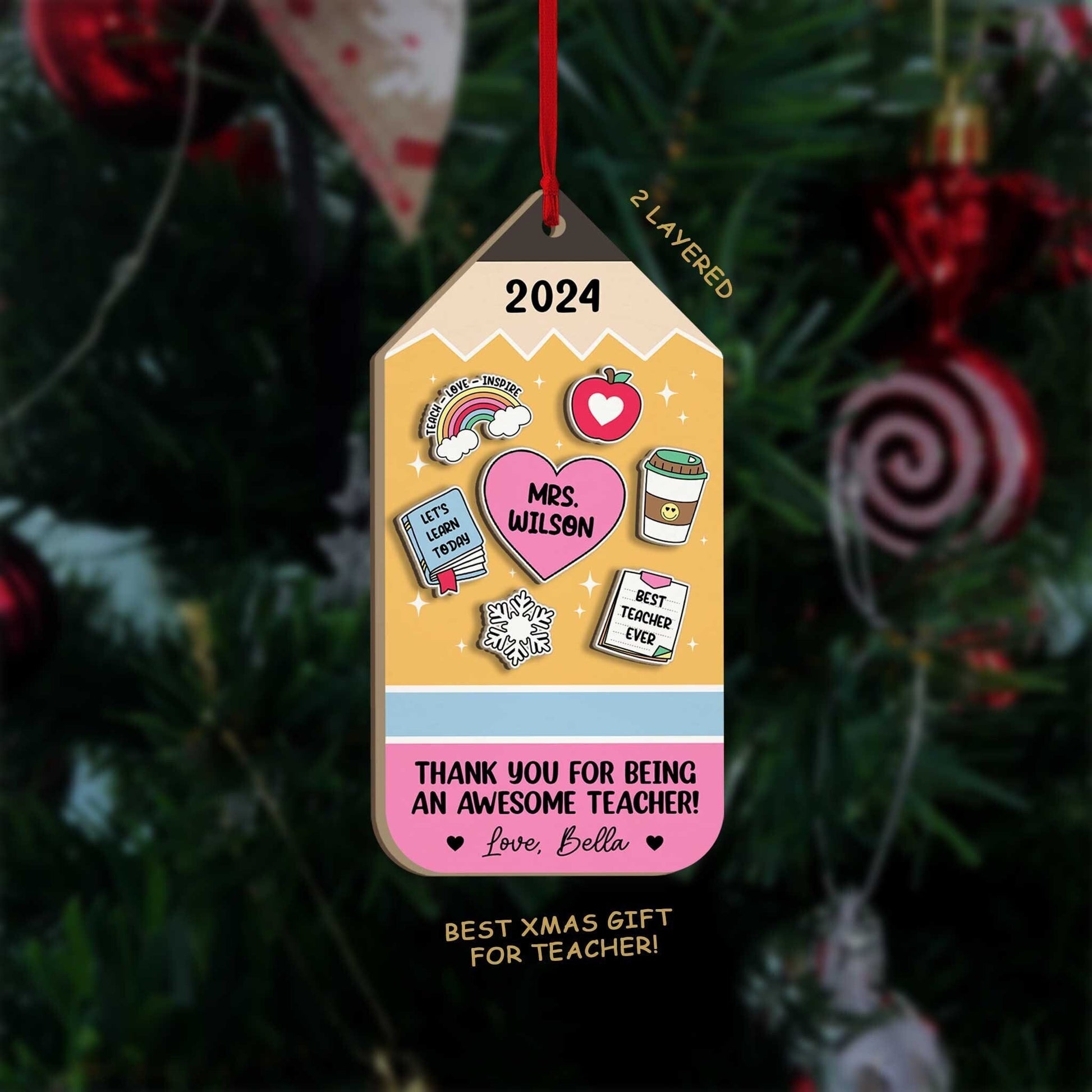 Vibrant tag-shaped ornament decorated with fun teacher-themed elements and personalized with Mrs. Wilson’s name. The message of appreciation from Love, Bella adds a thoughtful touch, making it a great keepsake for the 2024 holiday season.