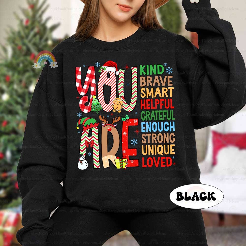 Whimsical design filled with festive patterns and affirmations such as Smart, Kind, and Brave. This cheerful T-shirt delivers a positive message while adding holiday fun.