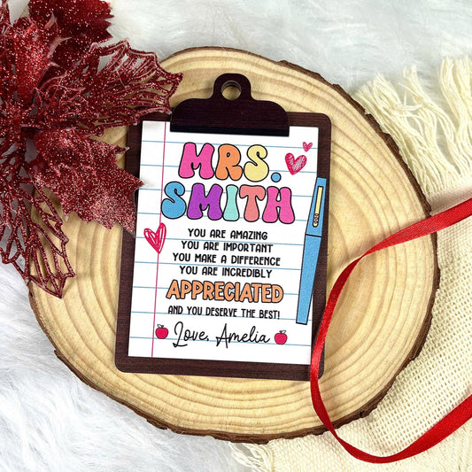 Charming clipboard-shaped ornament featuring a heartfelt message for Mrs. Smith, personalized with Love, Amelia. The colorful design highlights appreciation and gratitude, making it a perfect gift for teachers.
