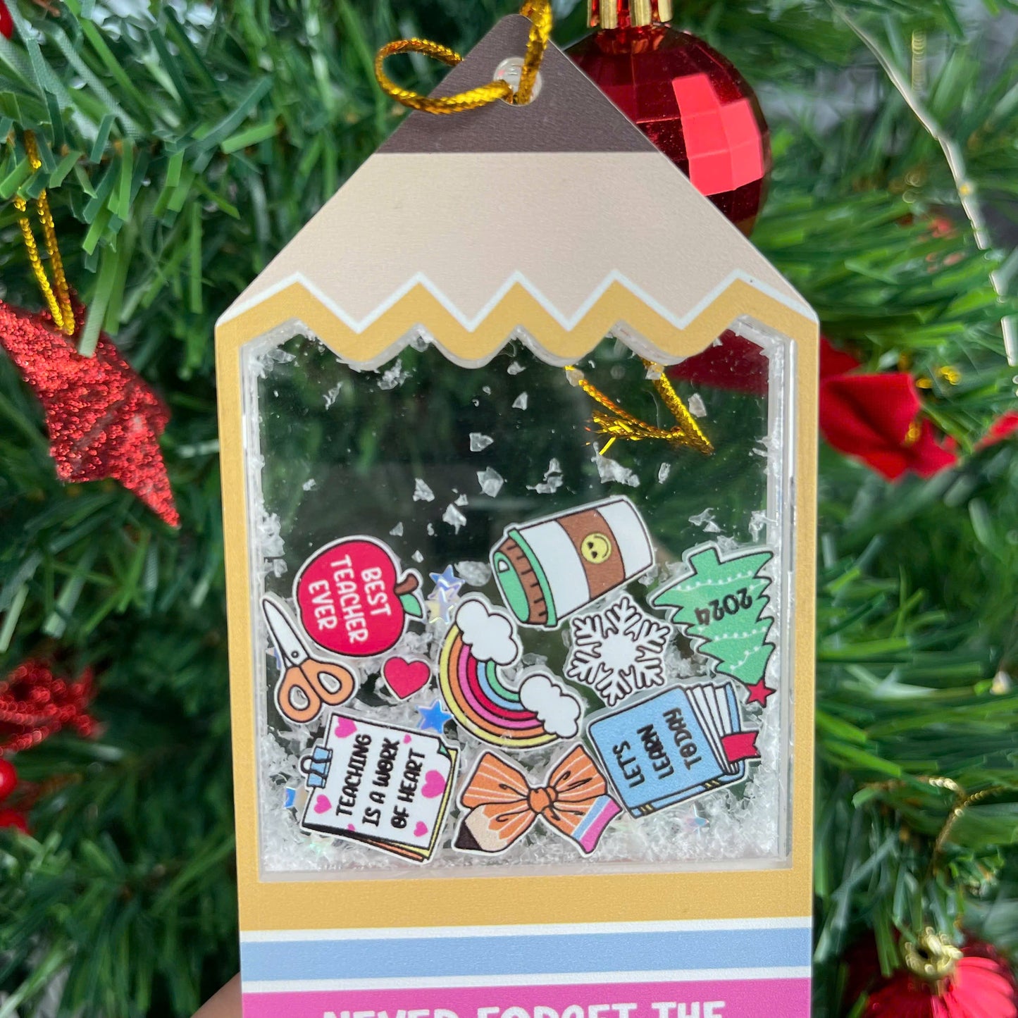 Cheerful and fun tag-shaped ornament with shakeable snow, decorated with cute school-themed icons like scissors, books, and a holiday tree. The personalized message for Mrs. Smith adds a thoughtful and festive touch.