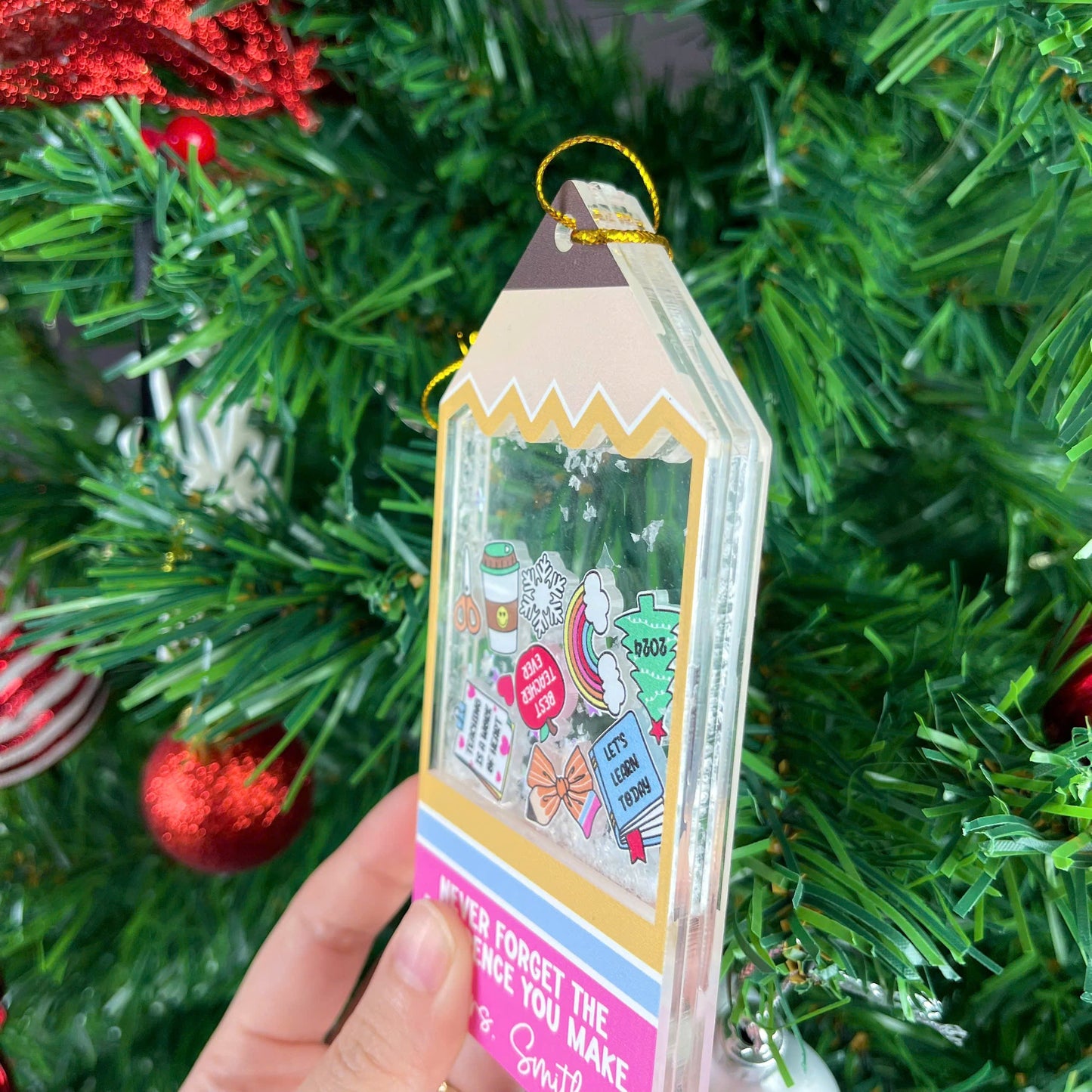 Playful tag-shaped ornament with a personalized message for Mrs. Smith, featuring fun icons and a shakeable snow effect. The phrase Never Forget the Difference You Make makes it a thoughtful teacher appreciation gift.