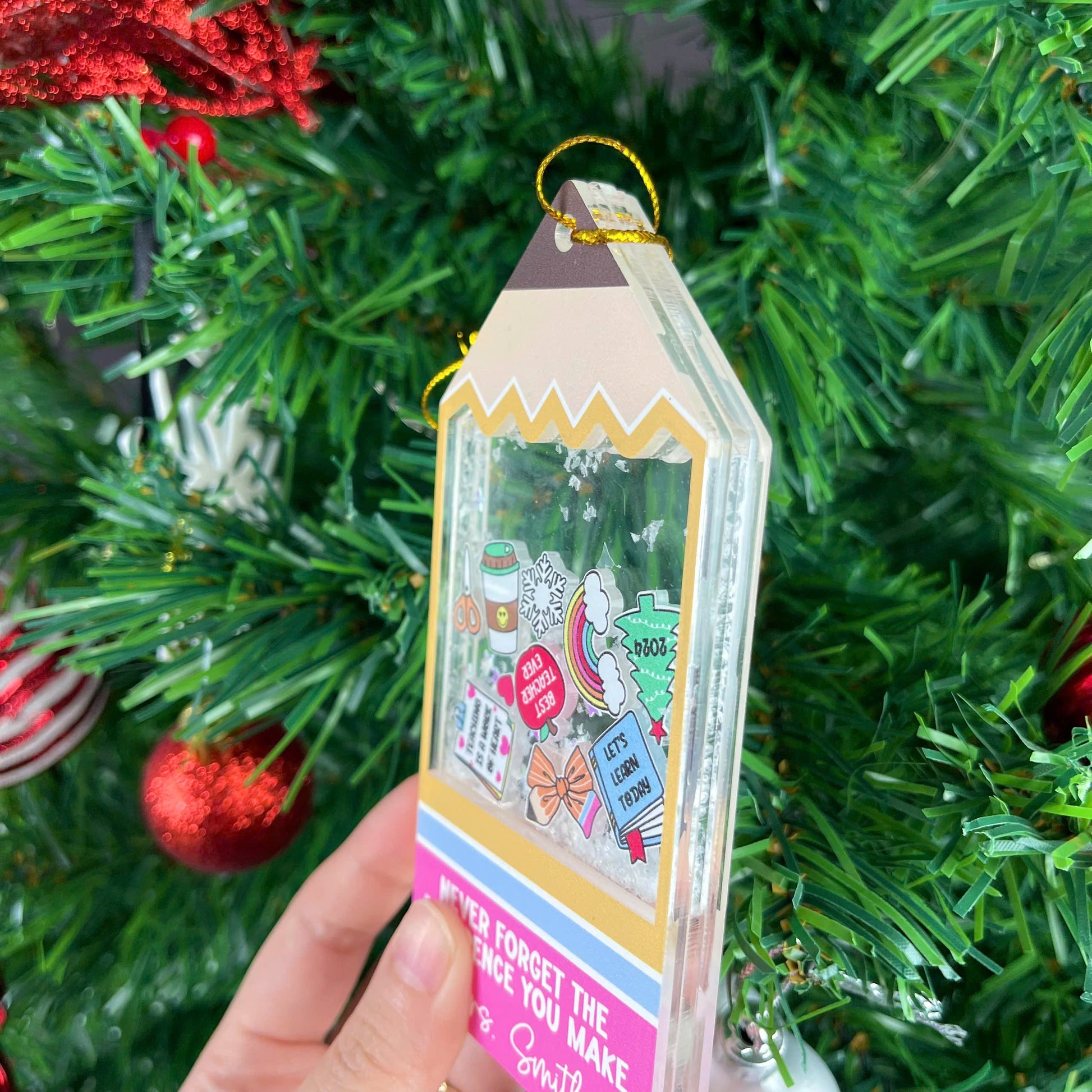 Playful tag-shaped ornament with a personalized message for Mrs. Smith, featuring fun icons and a shakeable snow effect. The phrase Never Forget the Difference You Make makes it a thoughtful teacher appreciation gift.