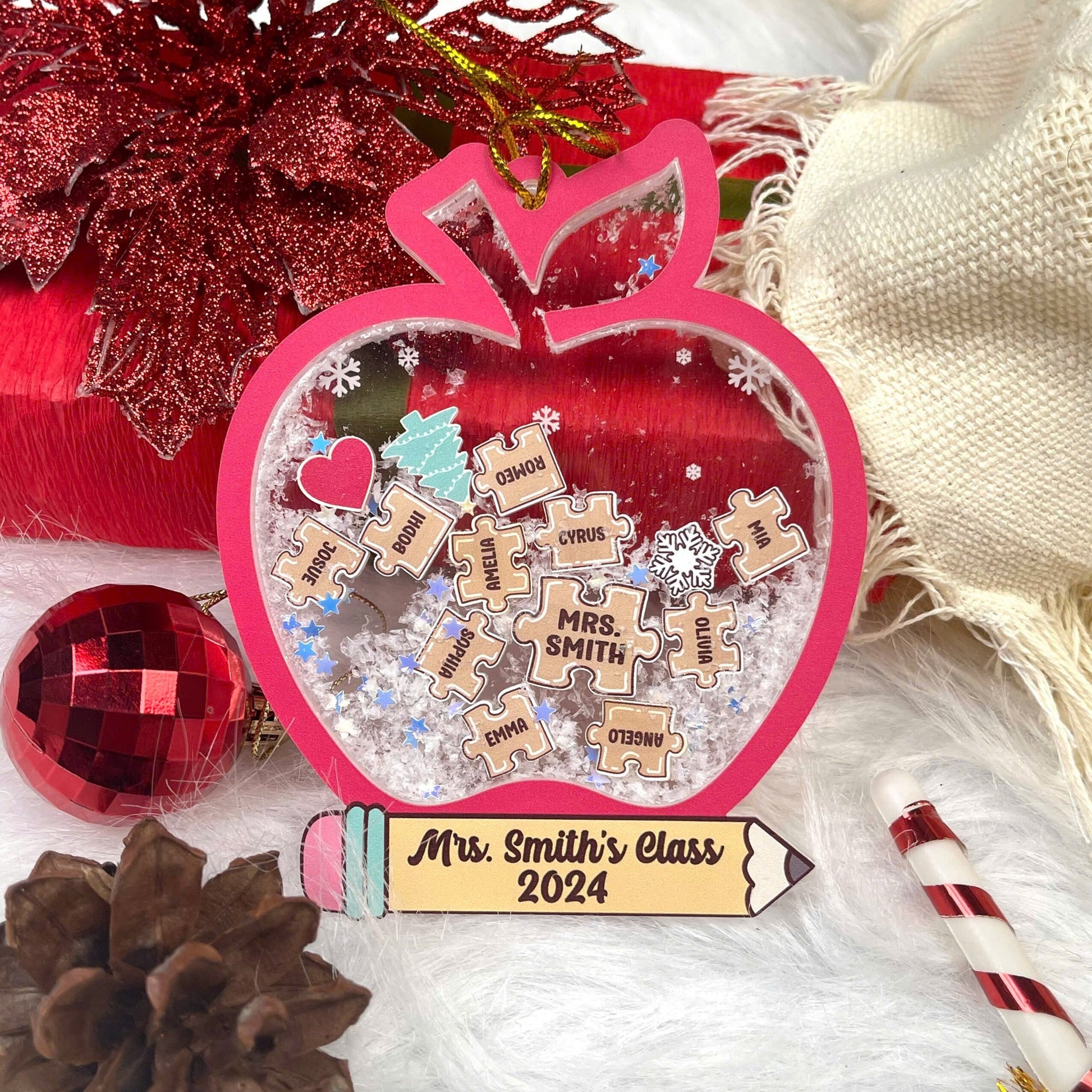 Playful and festive apple-shaped ornament with student names engraved on puzzle pieces, celebrating Mrs. Smith’s Class of 2024. The shakeable snow inside adds a fun and interactive holiday touch.
