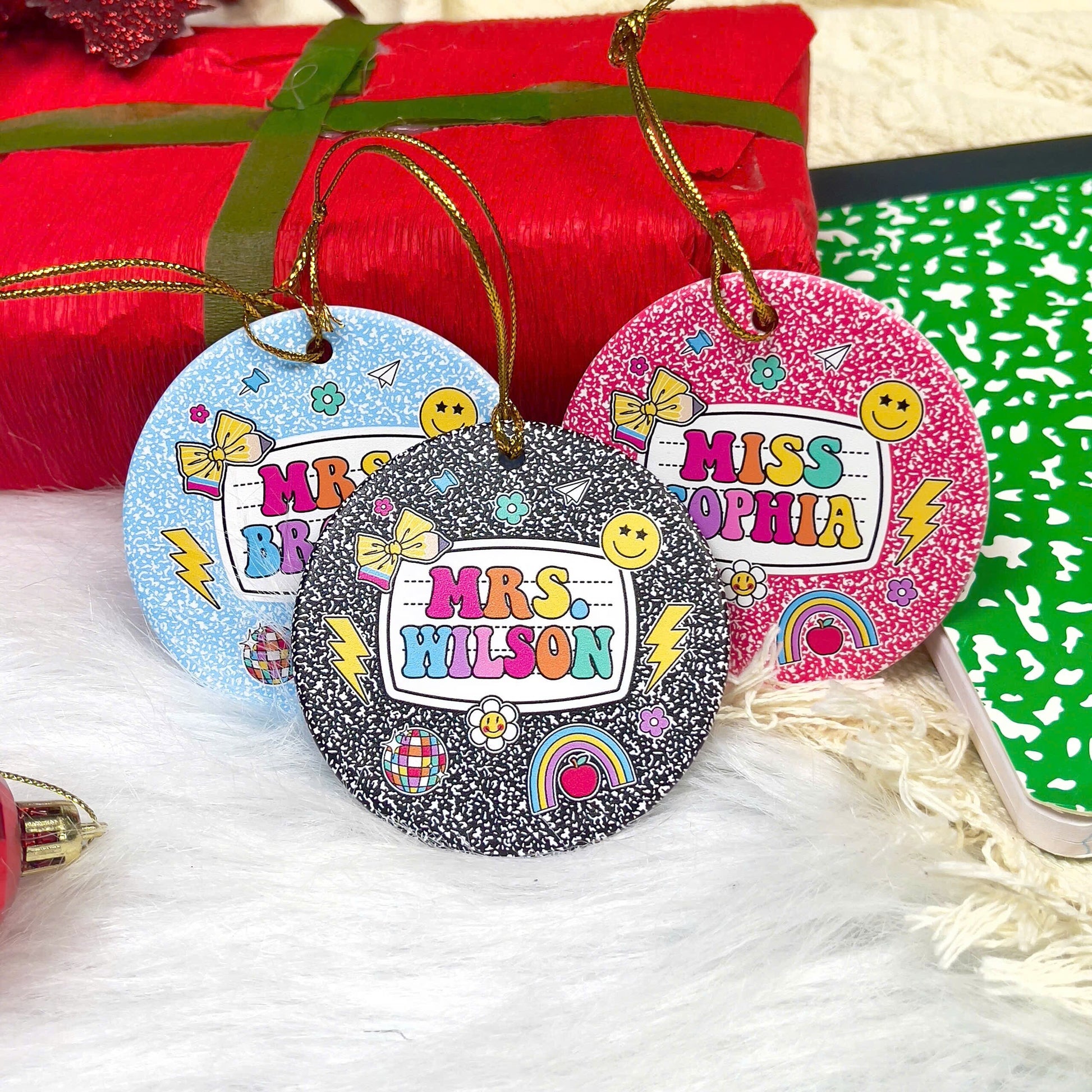 These vibrant, notebook-inspired ornaments feature teacher names in bold, colorful letters surrounded by fun classroom-themed icons such as bows, globes, and smiley faces. Perfect for adding a personalized and joyful touch to the holiday season.