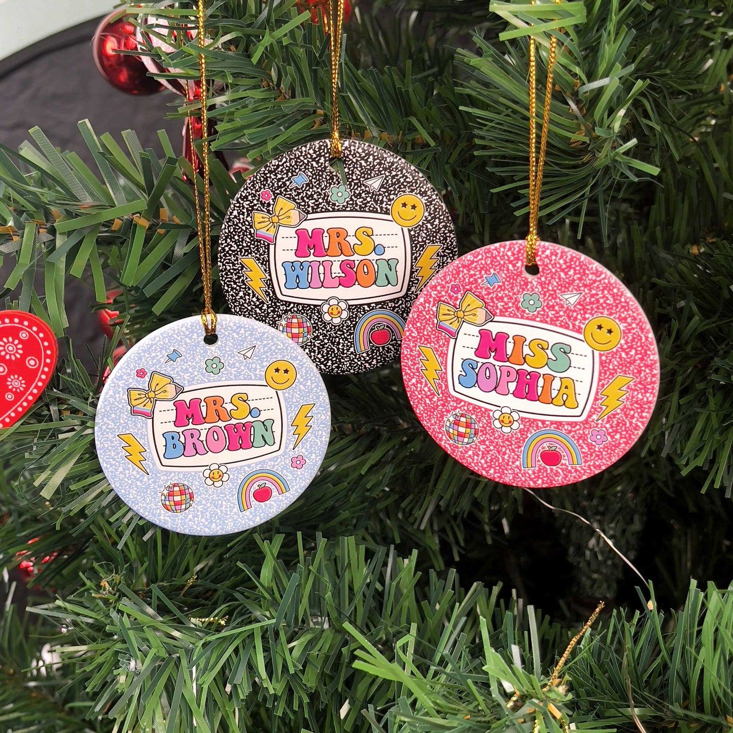 These festive round ornaments showcase teacher names with a joyful and colorful design, accented by playful elements like lightning bolts, bows, and globes. A perfect personalized gift for teachers to decorate their holiday tree.