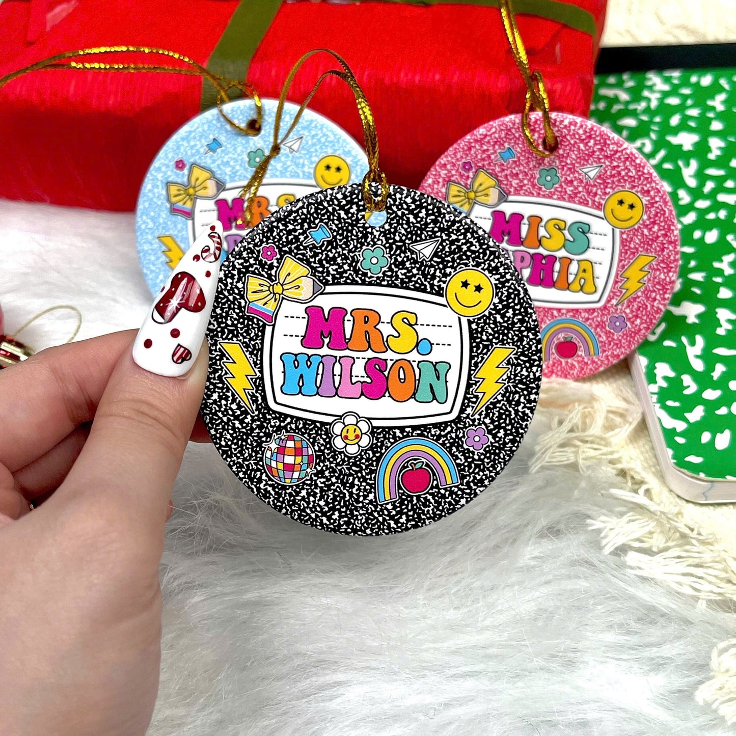These vibrant, notebook-inspired ornaments feature teacher names in bold, colorful letters surrounded by fun classroom-themed icons such as bows, globes, and smiley faces. Perfect for adding a personalized and joyful touch to the holiday season.