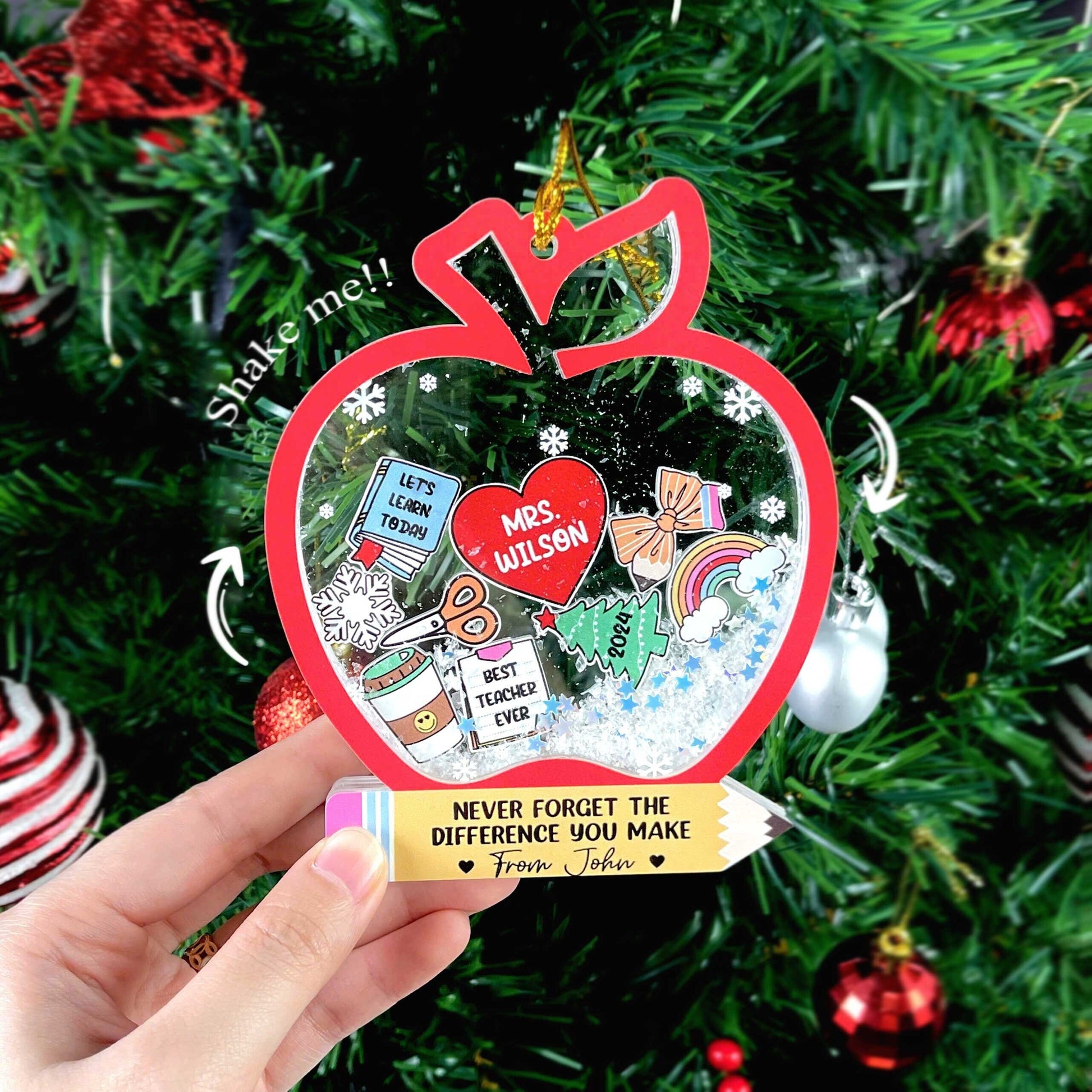 Playful and thoughtful ornament shaped like an apple with holiday-themed elements, including a personalized heart for Mrs. Wilson. With fun details like a snowflake and a pencil, this shakeable ornament is a perfect keepsake for teachers.