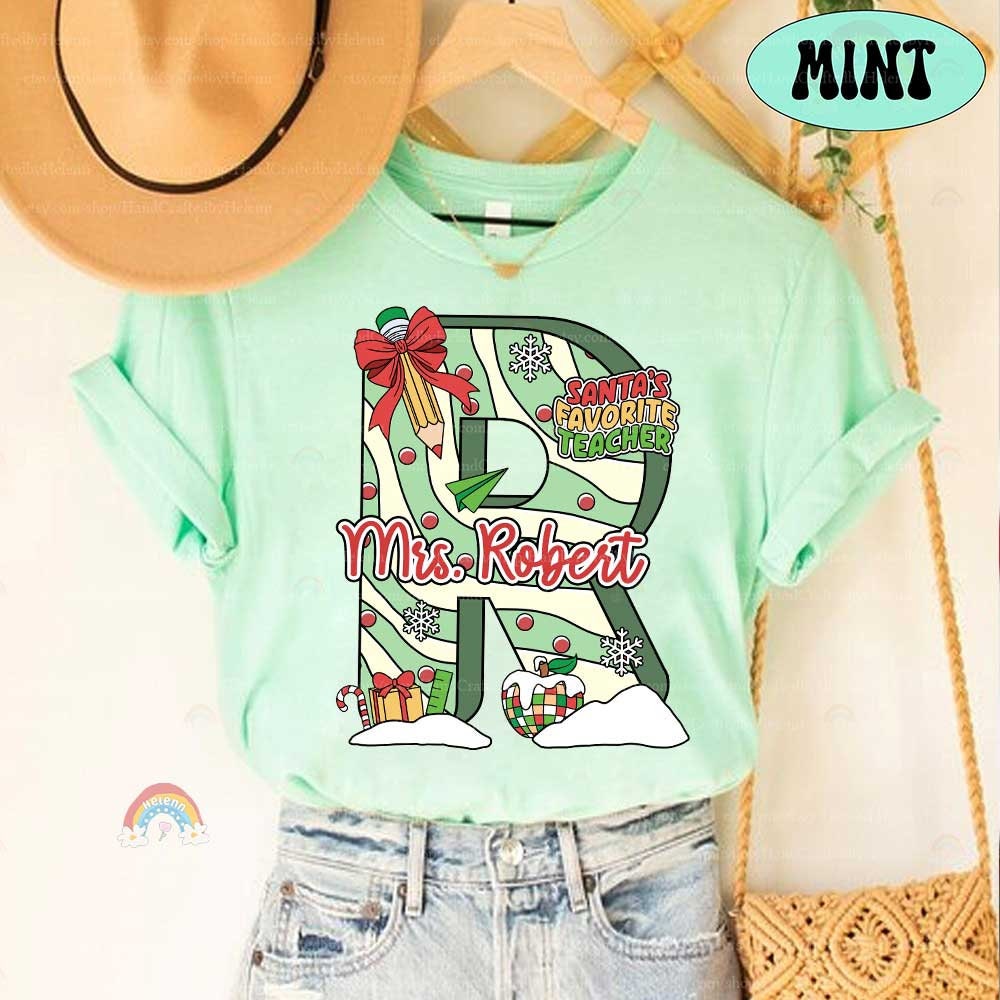 Charming holiday-themed design with a large, personalized letter, filled with seasonal decorations and the teacher’s name. Perfect for celebrating the holiday season with a unique and festive flair.